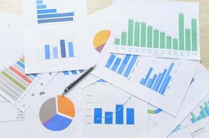 Top view of Documents with analytics data lying on table,selective focus photo