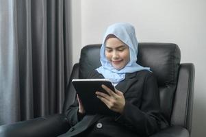 Young muslim business woman using tablet in modern office photo