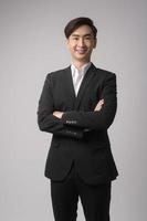 Young businessman wearing  suit over white background studio photo