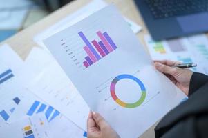 Top view of Documents with analytics data lying on table,selective focus photo
