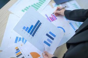 Top view of Documents with analytics data lying on table,selective focus photo