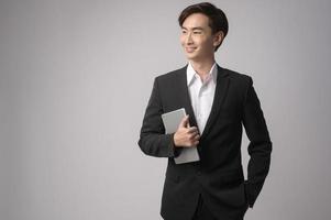 Young businessman wearing  suit over white background studio photo