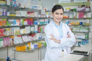 Portrait of female pharmacist working in a modern pharmacy drugstore. photo