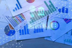 Background of documents with analytics data lying on table photo