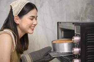 Young beautiful woman is baking in her kitchen , bakery and coffee shop business photo