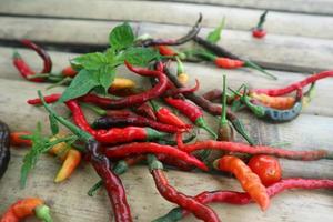 Hot chili peppers isolated on bamboo. Red and green Chile peppers plant photo