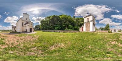 Full seamless hdri panorama 360 degrees angle view facade of church in decorative medieval gothic and baroque style architecture wirh bell tower in equirectangular spherical projection. vr content photo