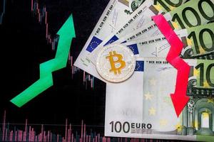 unprofitable investment of depreciation of virtual money bitcoin. Red and green arrow, silver bitcoin and euro go down on paper forex chart index background. Concept of depreciation of cryptocurrency. photo