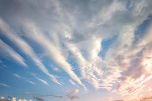 Blue sky background with tiny curly striped clouds in the evening. Clearing day and Good windy weather photo