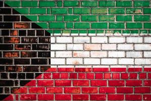 National  flag of the   Kuwait  on a grunge brick background. photo