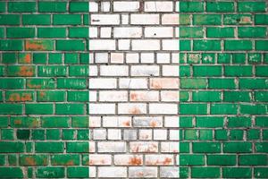 National  flag of the Nigeria  on a grunge brick background. photo