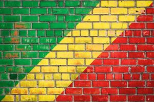 National  flag of the Republic of the Congo on a grunge brick background. photo