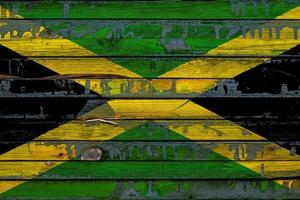 The national flag of Jamaica is painted on uneven boards. Country symbol. photo