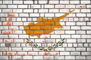 National  flag of the Cyprus on a grunge brick background. photo