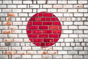 National  flag of the Japan  on a grunge brick background. photo