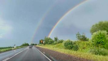 drive in the car in the rain during daylight hours. rainbow from the car window video