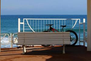 Bench in a city park on the Mediterranean coast photo