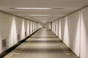 A narrow and long corridor on the lower floor of the building. photo