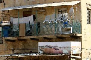 Outside the window, laundry is being dried on a rope on the facade of the building. photo