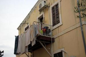 Outside the window, laundry is being dried on a rope on the facade of the building. photo