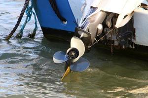 Motor and propeller of a motorboat. photo