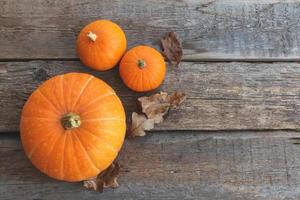 Autumnal Background. Natural autumn fall view pumpkins on wooden background. Inspirational october or september wallpaper. Change of seasons ripe organic food concept, Halloween party Thanksgiving day photo