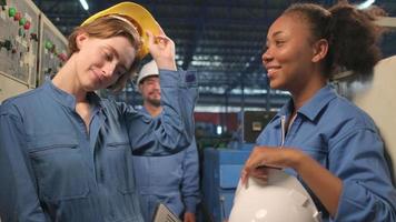 Multiracial professional engineer workers team take off hard hats after work and look at camera with cheerful smiles and positive expressions in industry manufacturing factory, happy technician duty. video