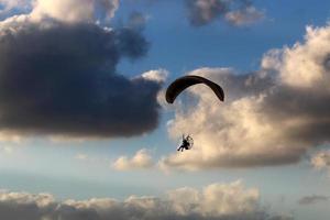 Nahariya Israel June 17, 2021. Paragliding in the sky over the Mediterranean Sea. photo