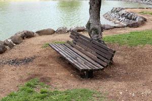 Bench for rest in the city park on the seashore. photo