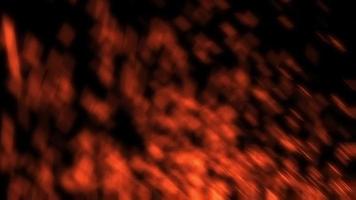 vurige rode achtergrond van wazig bewegende deeltjes. fel oranje vuur vlammen. video