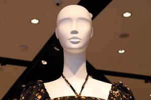 A mannequin stands on a showcase in a store. photo