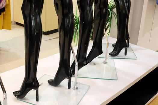 A mannequin stands on a showcase in a large store. photo