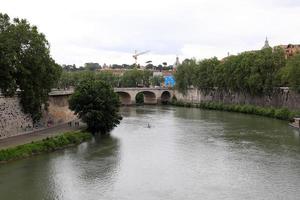 Rome Italy May 9, 2022 Full-flowing river Tiber in the center of Rome. photo