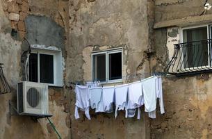 Outside the window, laundry is being dried on a rope on the facade of the building. photo