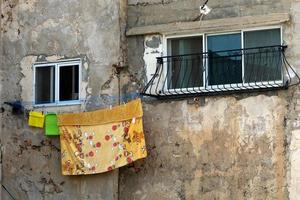 Outside the window, laundry is being dried on a rope on the facade of the building. photo