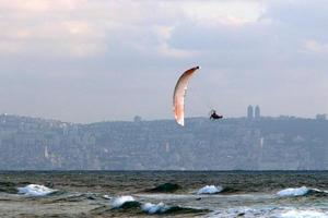Paragliding in the sky over the Mediterranean Sea. photo