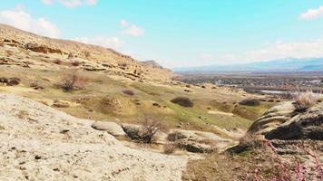 Aerial panoramic view of Uplistsikhe rock formation landscape in central Georgia. video