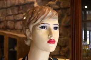 A mannequin stands on a showcase in a store. photo