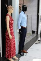 A mannequin stands on a showcase in a large store. photo