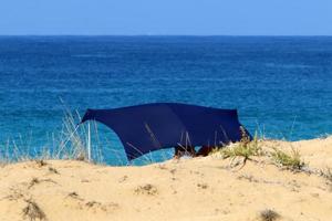 Tent for rest on the shores of the Mediterranean Sea. photo