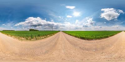 full seamless spherical hdri panorama 360 degrees angle view on gravel road among fields in summer day with awesome clouds before storm in equirectangular projection, for VR AR virtual reality content photo