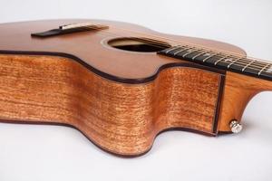 wood texture of lower deck of six strings acoustic guitar on white background. guitar shape photo