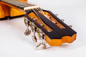 wood texture of lower deck of six strings acoustic guitar on white background. guitar shape photo