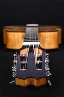 Tuning pegs on wooden machine head of six strings guitar on white background photo