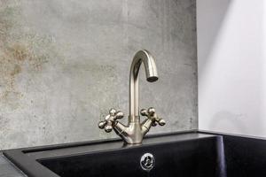 Water tap sink with faucet in expensive loft kitchen photo