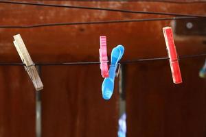 Washed linen dries on the street outside the window of the house. photo