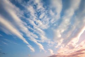 Blue sky background with tiny curly striped clouds in the evening. Clearing day and Good windy weather photo