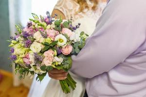 bright wedding bouquet of summer white pink roses and orchid with violet wildflowers photo