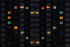 panorama nocturno plano de luz de corazón multicolor en ventanas de edificios de varios pisos como concepto para una pareja enamorada foto