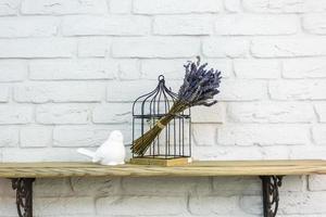 interior decoration toys. White decorative bird near cage in expensive loft interior photo